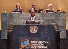 Barbados foreign minister at UN podium discussing migration policies