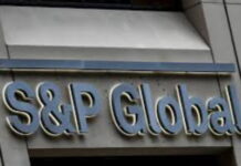 BERMUDA-Government welcomes latest S&P ratings. Bermuda government official holding S&P rating report with positive outlook
