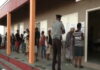ANTIGUA-Antiguans voting for a new government. Antigua citizens casting ballots at polling station with national flags