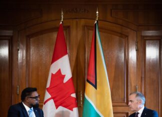 GUYANA-Canada, Guyana leaders emphasize ‘strong’ ties. Canadian and Guyanese leaders shaking hands at bilateral meeting
