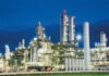 TRINIDAD-Government urged to make a statement on the possible shutdown of the methanol producer. Industrial plant exterior with "Methanol Producer" sign and empty parking lot