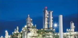 TRINIDAD-Government urged to make a statement on the possible shutdown of the methanol producer. Industrial plant exterior with "Methanol Producer" sign and empty parking lot