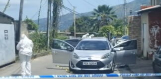 TRINIDAD-Toddler among three people murdered in broad daylight Police officers at crime scene with yellow tape in Trinidad neighborhood