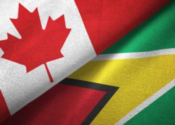 Guyana and Canada flags together textile cloth, fabric texture
